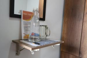 a bottle sitting on a shelf next to a blender at Living Poblado Manila 301 C Habitación Individual in Medellín