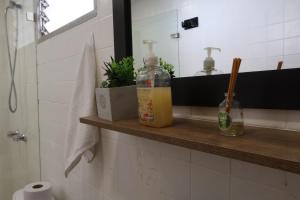a bathroom with a bottle of soap on a shelf at Living Poblado Manila 301 C Habitación Individual in Medellín +50 photos