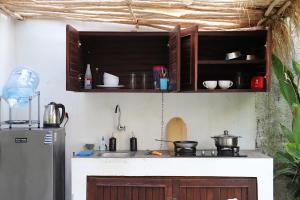 a kitchen with a sink and a refrigerator at Bungalow Villa with Private Pool near Canggu in Dalung