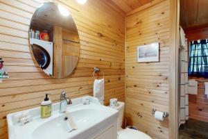 a bathroom with a white sink and a mirror at Sunflower Cottage in Freeport +8 photos