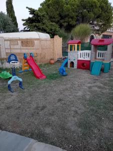 a playground with several play equipment in a yard at Giola aparments and studios 2 in Astris