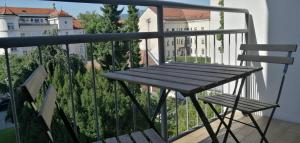 a table and two chairs on a balcony with a view at city center park view appartment in Maribor