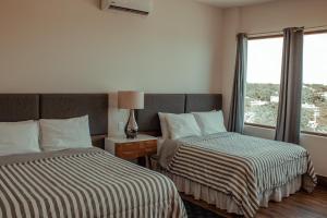 Postel nebo postele na pokoji v ubytování Sky Inn Hotel - Cancun