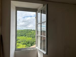 an open window with a view of a forest at Au Cœur de GENSAC, village de charme dominant la Dordogne in Gensac