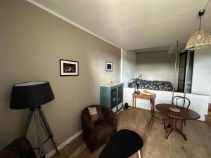a living room with a couch and a table at Au Cœur de GENSAC, village de charme dominant la Dordogne in Gensac