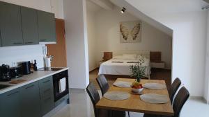 a kitchen and dining room with a table and a bed at The Father's House in Bol
