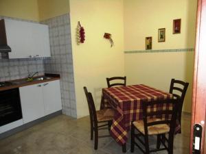 a kitchen with a table and chairs and a kitchen with a sink at Agriturismo Terre D'Ulivi in Moscufo