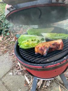 a grill with some meat and vegetables on it at Bell tent Boven Duin in 't Horntje