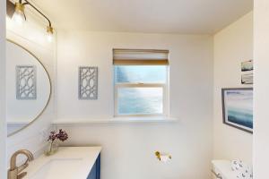 a bathroom with a sink and a window at Jewel by the Sea in Cambria +22 photos