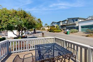 a blue table and chairs sitting on a balcony at Jewel by the Sea in Cambria