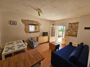 a living room with a blue couch and a table at Apartman Marina in Zagorje