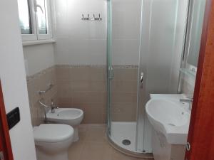 a bathroom with a shower and a toilet and a sink at Casa Vacanze " ORTE " in Otranto +17 photos