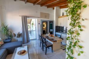 a kitchen and living room with a table and a couch at Evelina 5 in Lixouri +11 photos