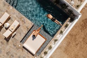 an overhead view of a man swimming in a swimming pool at Naxos Aristocratic Villa in Galanado