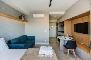 a room with a bed and a couch and a table at Studio Completo ao Lado da PUCRS CON1506 in Porto Alegre