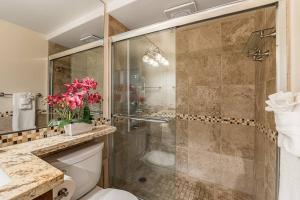 a bathroom with a shower and a toilet and a sink at KS507 Spectacular Oceanfront with Split AC Wailea in Wailea +22 photos
