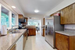 a kitchen with a stainless steel refrigerator and wooden cabinets at Bayview Reach in Tillamook +18 photos
