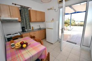 a kitchen with a table with fruit on it at Long Beach Koutsounari in Ierápetra