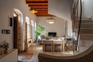 a living room with a couch and a table at Triada Manor House in Heraklion