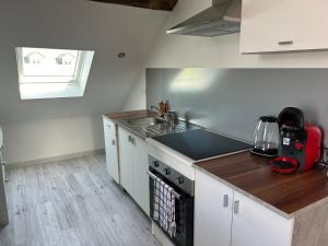 a kitchen with a sink and a stove top oven at Les Nids in Dieppe +34 photos