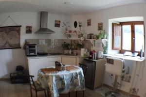 a kitchen with a table and a small kitchen with a refrigerator at PequeñoCabárceno in Solares +67 photos