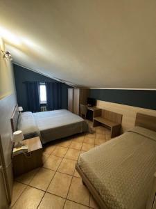 Postel nebo postele na pokoji v ubytování Albergo Carla