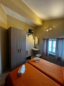 Postel nebo postele na pokoji v ubytování Albergo Carla
