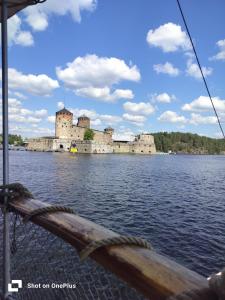 a view of a castle from a boat on a body of water at Retro House in Savonlinna