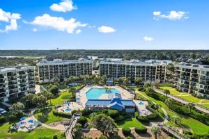 an aerial view of an apartment complex with a pool and resort at Beach and Golf Oceanfront 3 Bdrm Newly Renovated in Pawleys Island