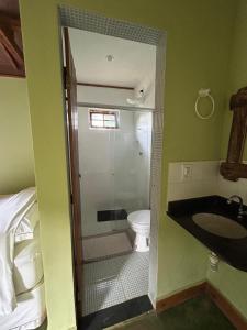 a bathroom with a shower and a toilet and a sink at Vale das Quaresmeiras in Divisa +66 photos