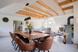 a dining room with a wooden table and chairs at Ferienwohnung 12 Monkeys in Stuhr