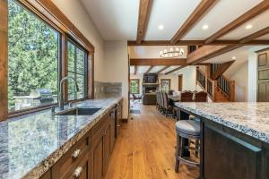 a kitchen with a large island with a counter top at Arcadia Manor on the West Shore - Newly Built - 5 BR w Wet Bar EV Charger and Air Conditioning in Tahoe City