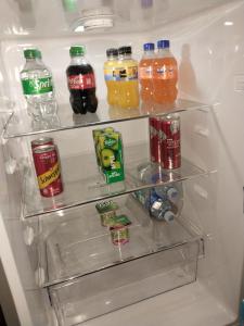 an open refrigerator filled with drinks and soda at De La Grace in Potchefstroom