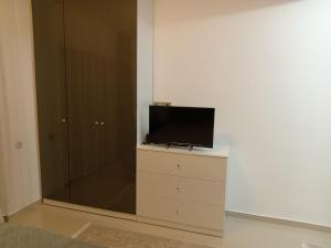 a tv sitting on top of a dresser in a room at Perla Marii Penthouse in Eforie Nord