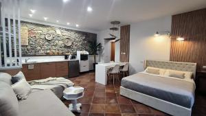 a living room with two beds and a kitchen at Villa Marchesa in Arona