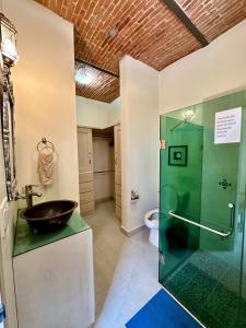 a bathroom with a sink and a glass shower at Villas San Juan Cosala in San Juan Cosalá