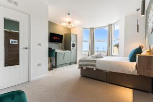 a bedroom with a bed and a sink at Redcar Beach Suites in Redcar