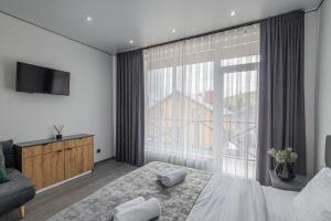 Un dormitorio con una cama y una ventana grande en Haya Villa, en Bukovel