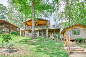 an exterior view of a house with a tree at Hot Springs Retreat with Private Dock and Hot Tub! in Hot Springs