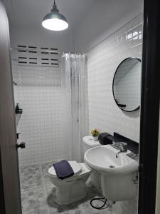 a bathroom with a sink and a toilet and a mirror at 34house in Betong +59 photos