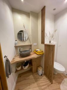 a bathroom with a sink and a toilet at Cyprès du château in Le Barroux +20 photos