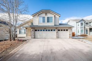 a house with a garage in front of a driveway at Brand New Studio Apartment in Great Neighborhood in Colorado Springs