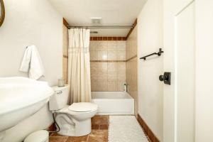 a bathroom with a toilet and a sink and a tub at Brand New Studio Apartment in Great Neighborhood in Colorado Springs +10 photos