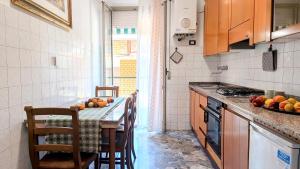 a kitchen with a table with fruits on it at MaisonV-Vivi il centro e il mare in Porto San Giorgio