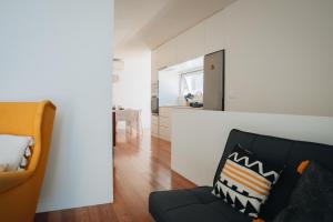 a living room with a couch and a mirror at Sea & Rocks 15 - House in Lagoa