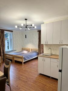 una camera con letto e una cucina con lavandino di Evergreen Surami Hotel a Surami