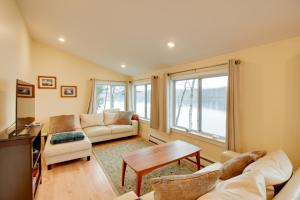 a living room with two couches and a table at Falmouth Vacation Rental On Highland Lake! in Falmouth