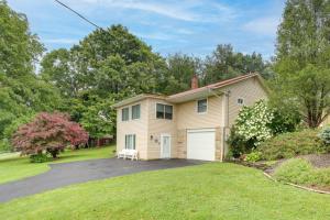 a house with a driveway and a garage at Montour Falls Apartment about 3 Mi to Seneca Lake! in Montour Falls