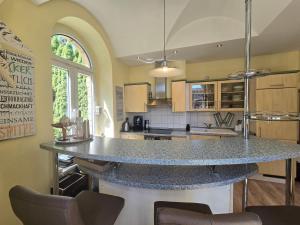 a kitchen with a large island in the middle at Palais Picard Westflügel in Thale