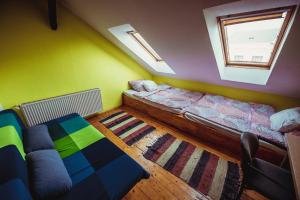 a living room with a bed and a couch at Unity Hostel Budapest in Budapest